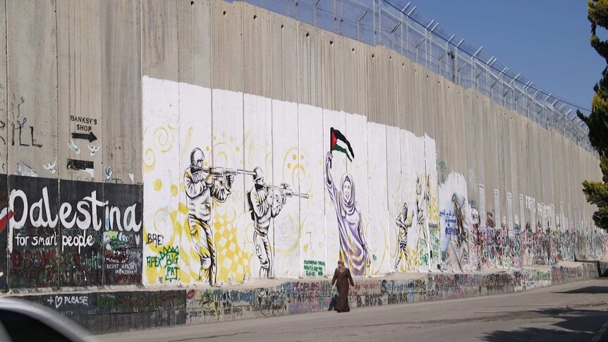 The separation barrier with graffiti and pictures painted on it
