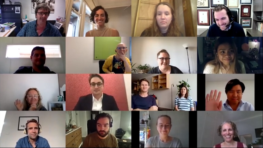 A screenshot from a Zoom conference call shows 16 people smiling or waving at the camera.