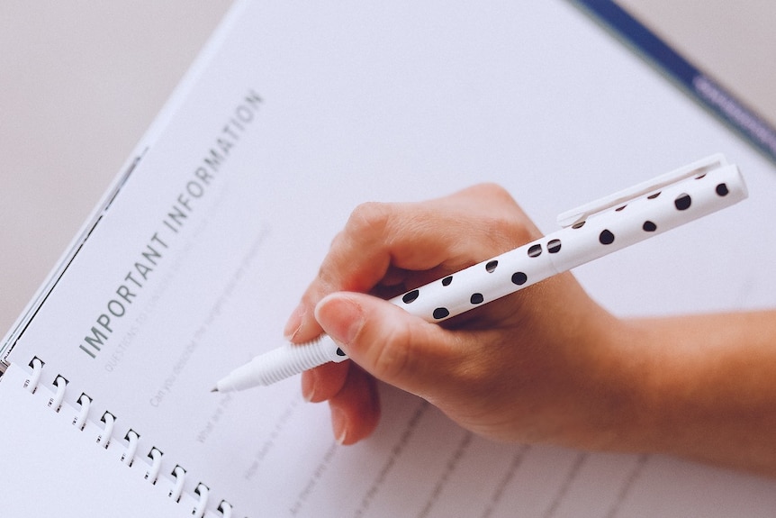 A person writing in a diary with a clean white layout, under the heading "Important Information".