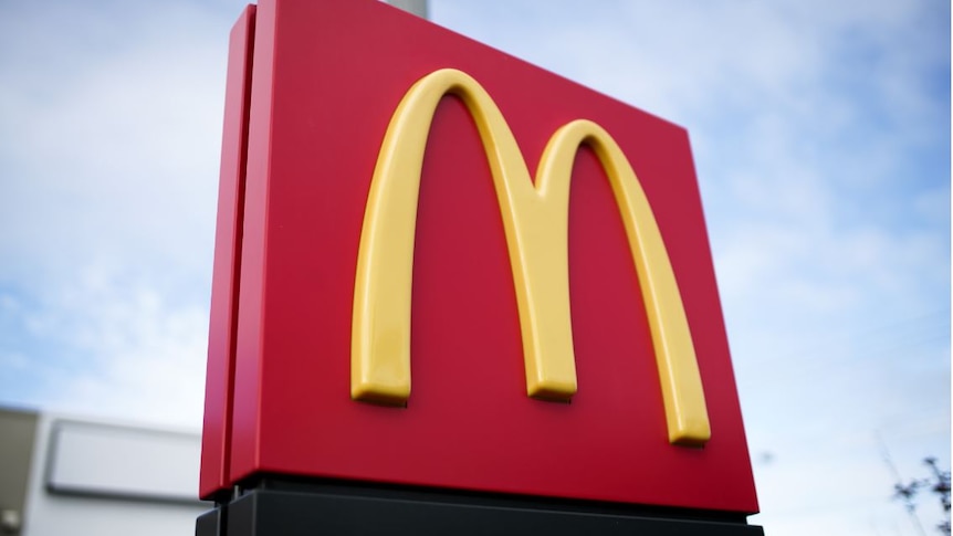 A yellow M on a red square sign