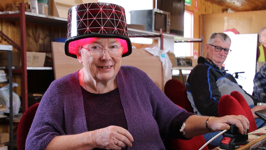 A woman wears a light bucket helmet