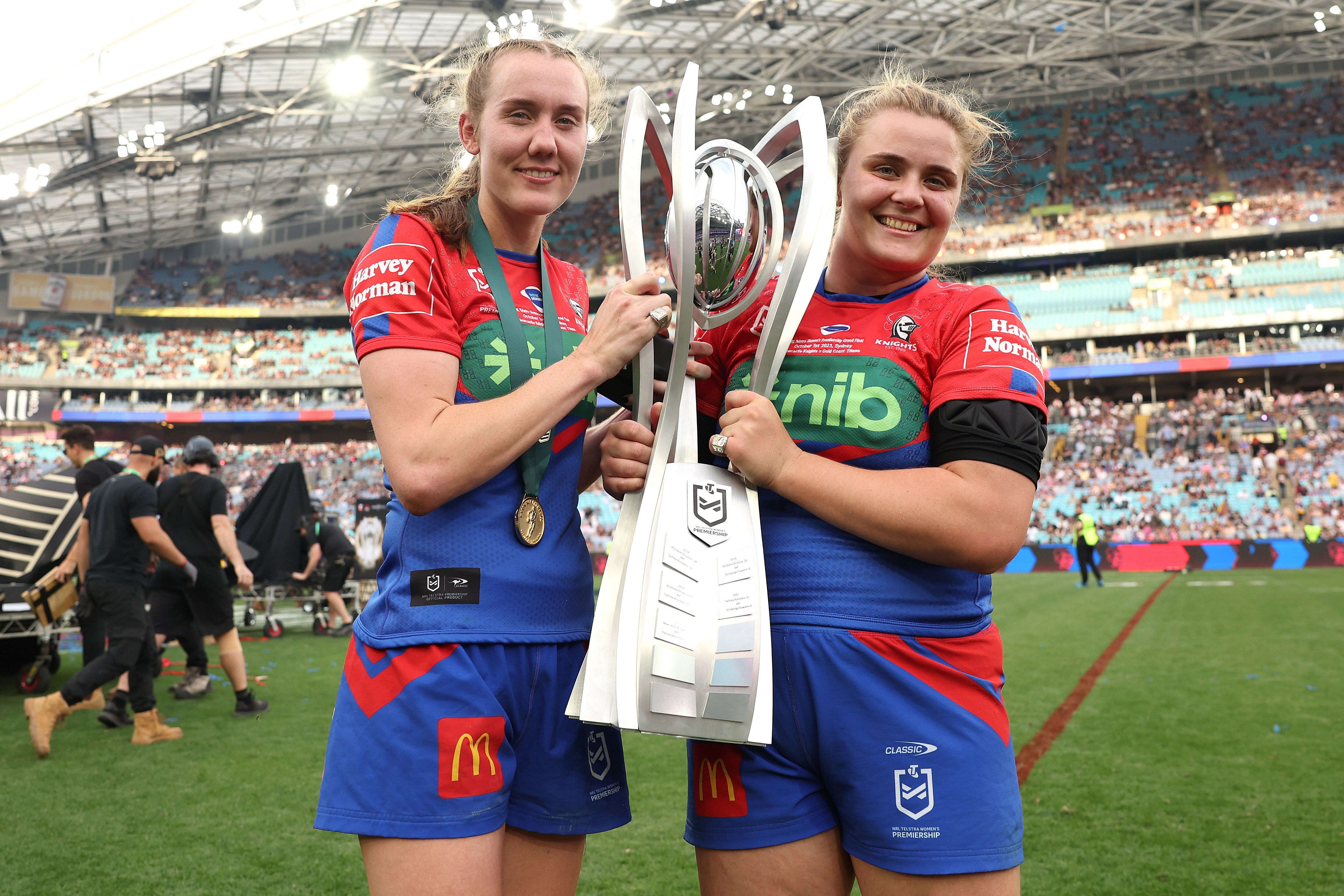 Tamika Upton and Hannah Southwell with the NRLW premiership trophy.