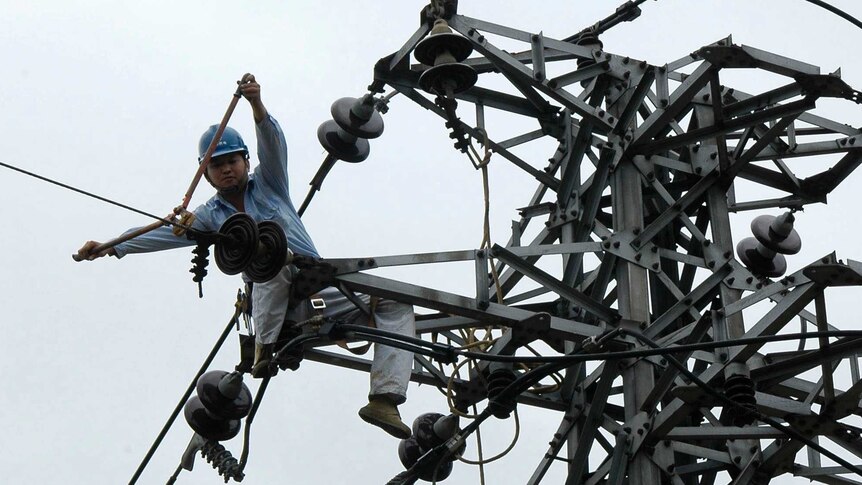 Electrician works on power transmission in China