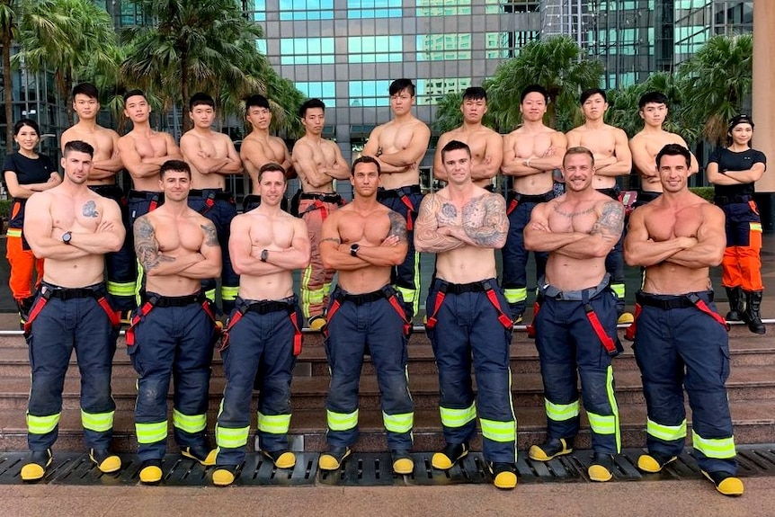 Six Australian firefighters pose with 12 Taiwanese firefighters for the launch of their joint calendar in 2019.