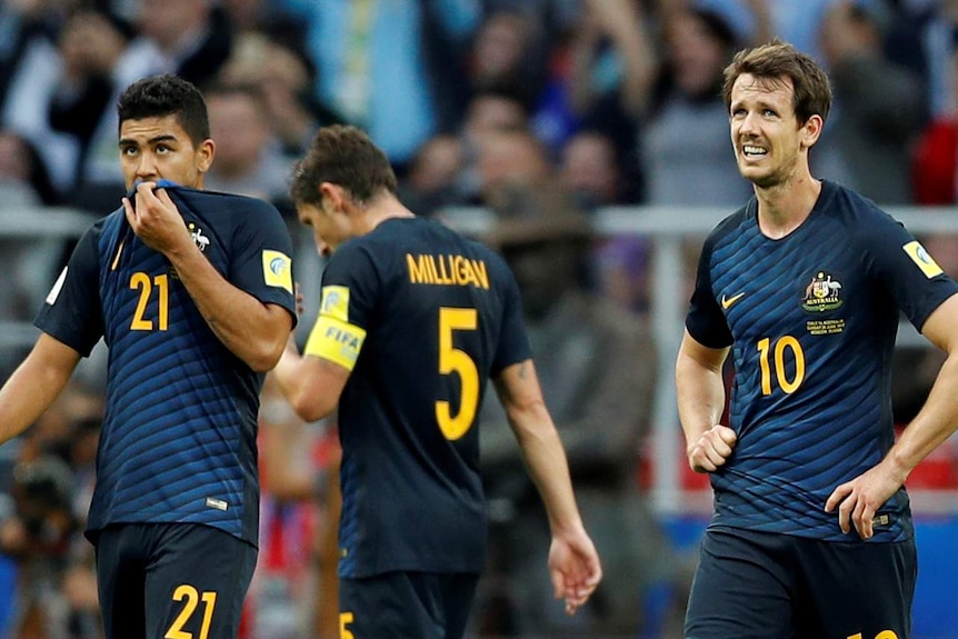 The Socceroos show their dejection after the draw with Chile at the Confederations Cup.