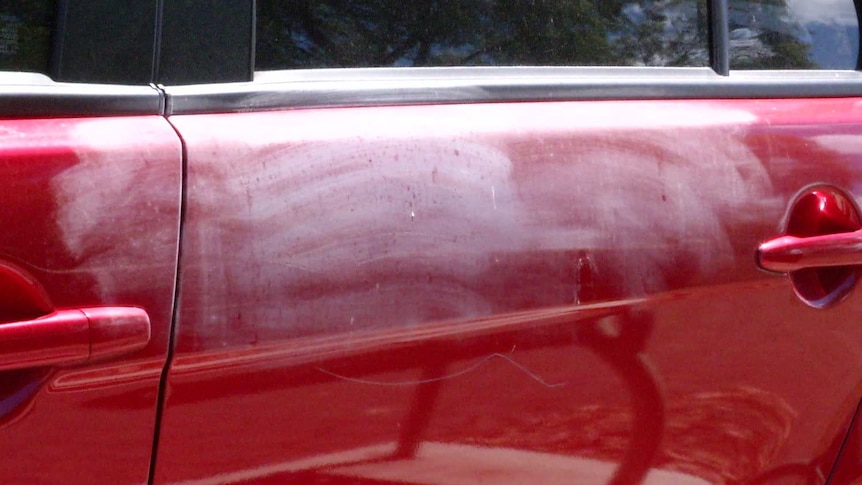 white marks on a red car
