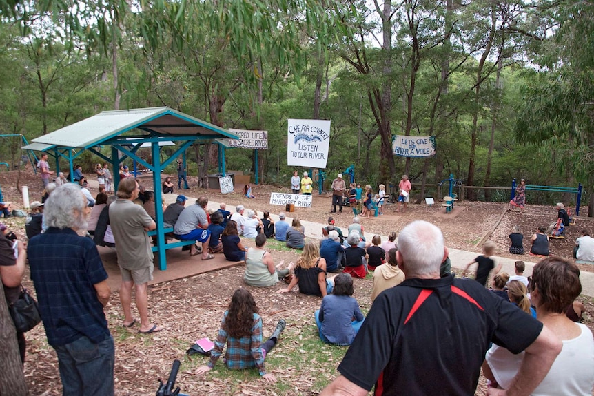 A community rally in a park on the banks of the Margaret River