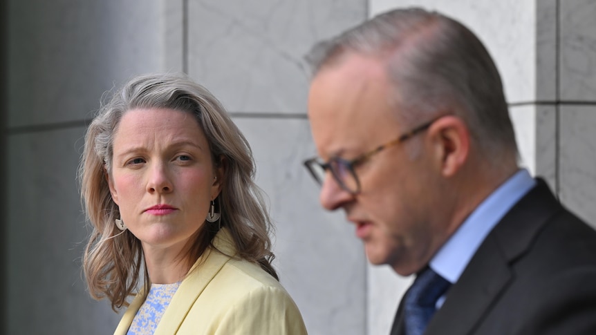 Clare O'Neil looks towards Anthony Albanese at a joint press conference in the Prime Minister's courtyard at Parliament House. 