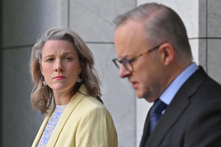Clare O'Neil looks towards Anthony Albanese at a joint press conference in the Prime Minister's courtyard at Parliament House. 