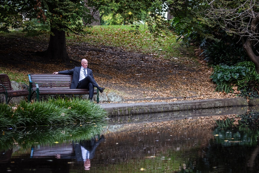 a man in a suit at a park