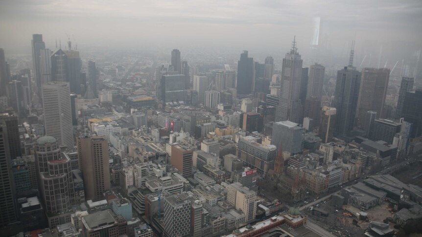 Melbourne's CBD with a layer of brown haze that looks like fog.