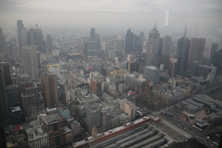 Melbourne's CBD with a layer of brown haze that looks like fog.