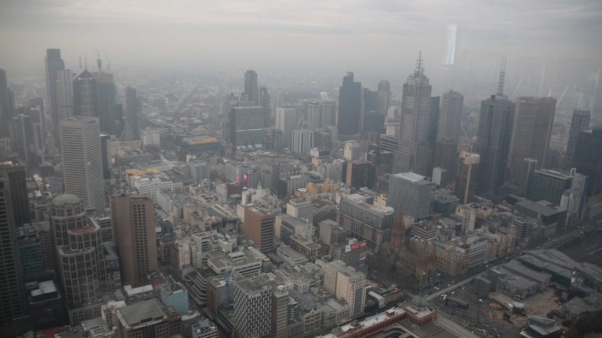 Melbourne's CBD with a layer of brown haze that looks like fog.