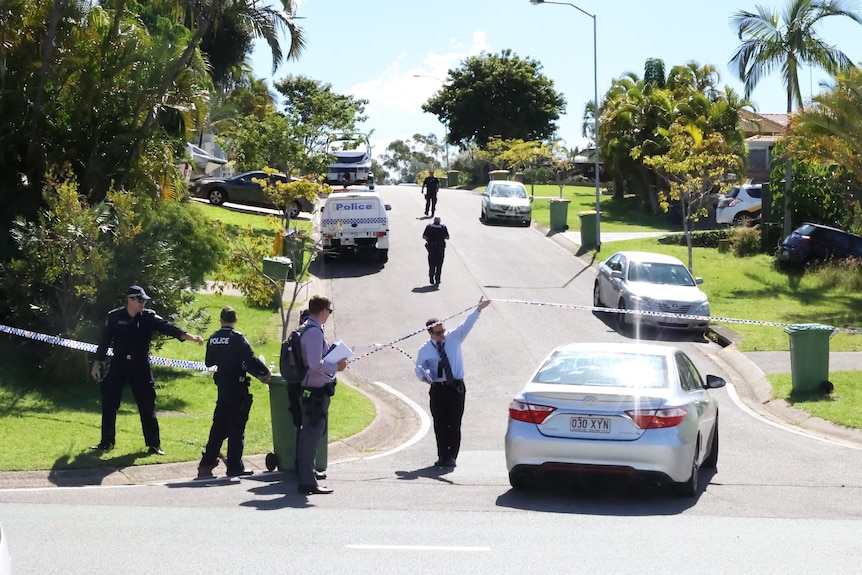 Police tape blocks a street 