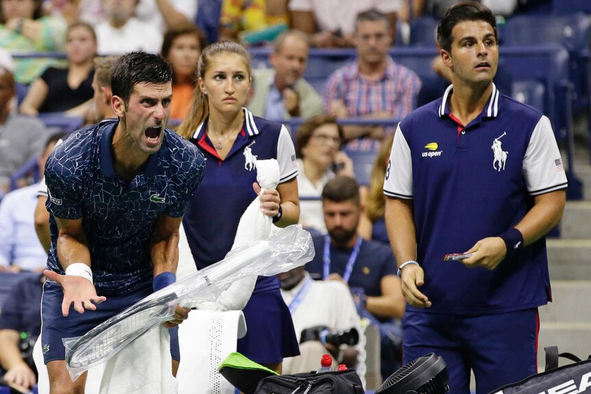 Novak Djokovic leans forward and yells, hand outstretched low, as he holds plastic wrapped tennis racket.