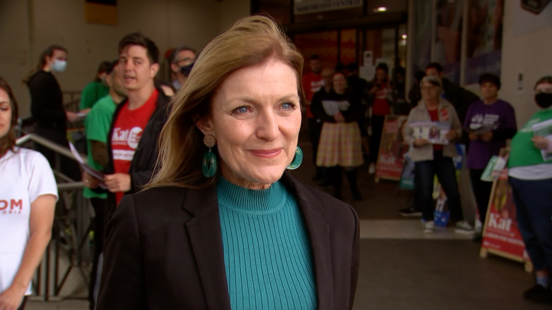 A woman standing in front of an election pre-polling station