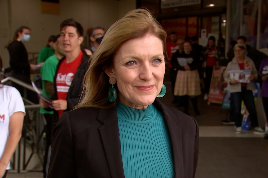 A woman standing in front of an election pre-polling station