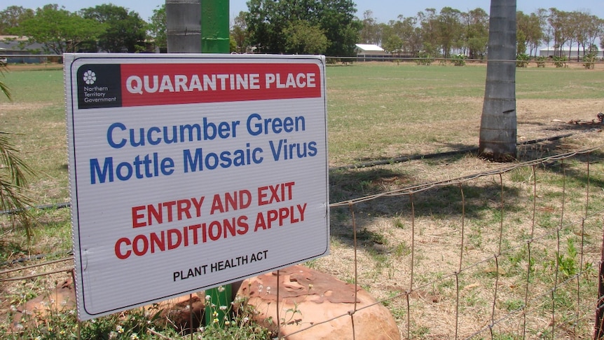 Quarantine sign on a farm fence.