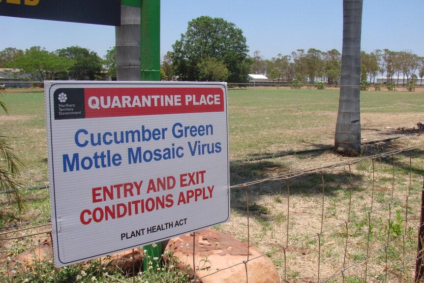 Quarantine sign on a farm fence.