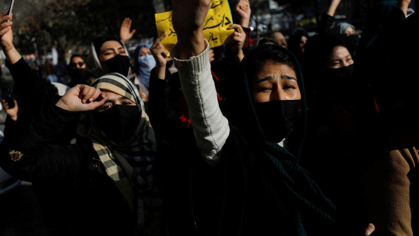 Afghan women chant slogans in protest against the closure of universities.