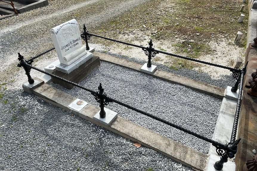 Jessie Rooke's grave after restoration. The wrought iron has been restored and the headstone is legible.
