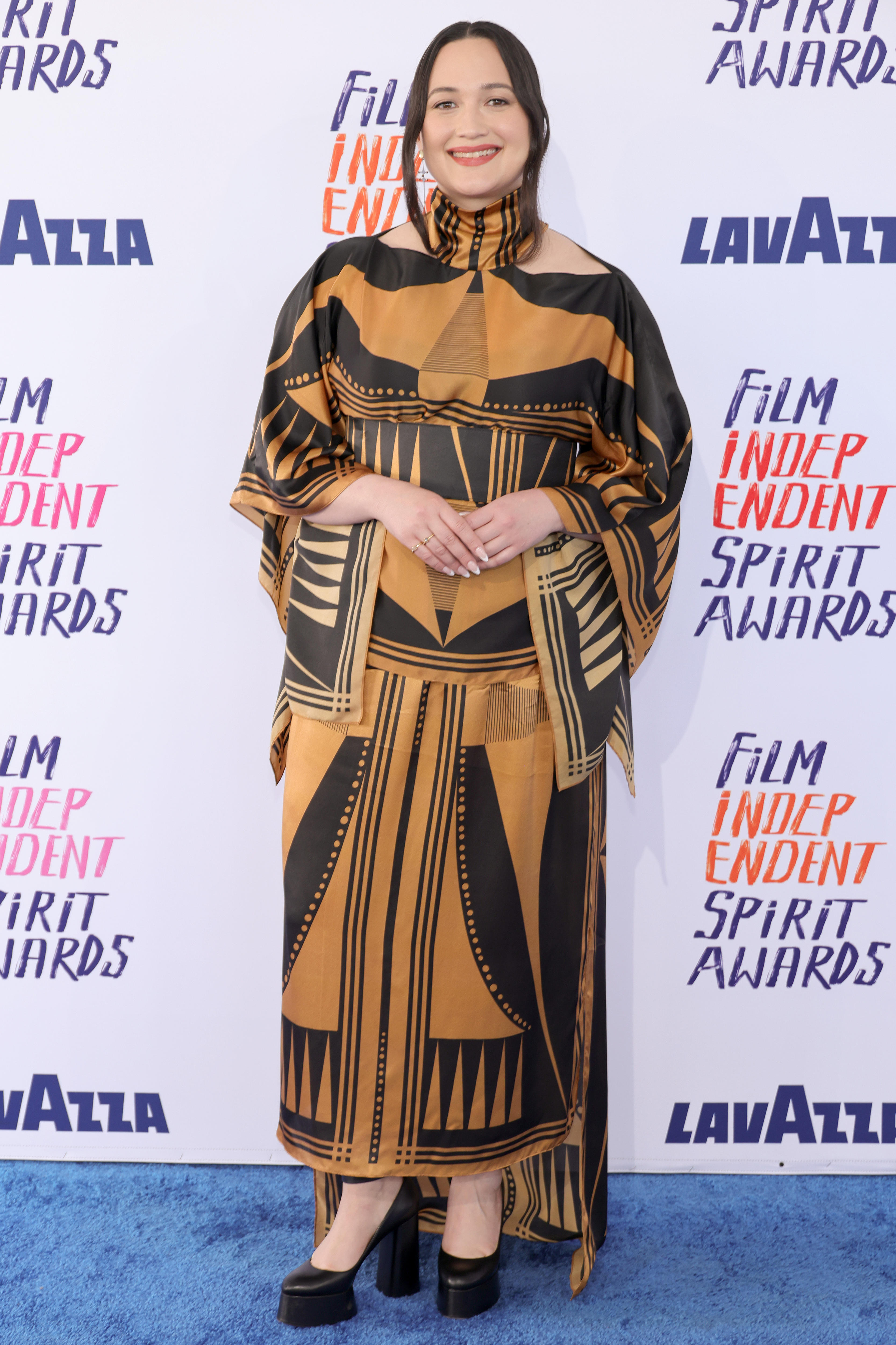 Lily Gladstone poses on the red carpet at the Independent Spirit awards