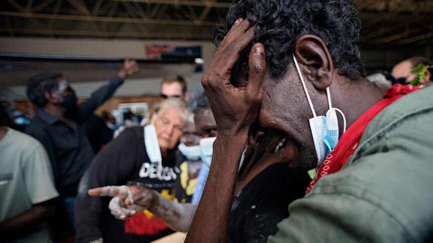 A man crying at a funeral ceremony for Australian actor David Gulpilil