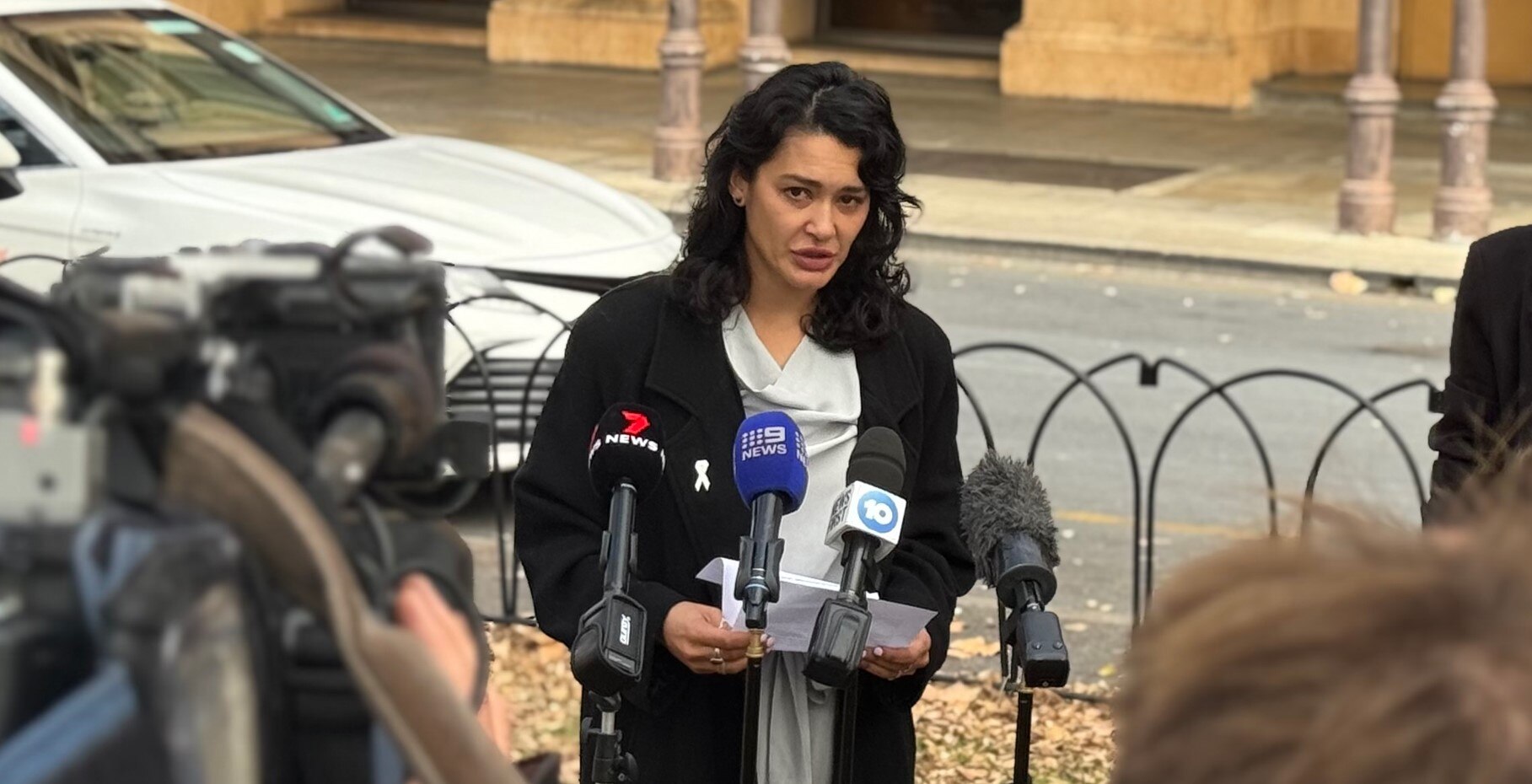 A survivor delivering a statement outside court.