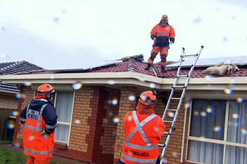 SES crews on the roof of a house.