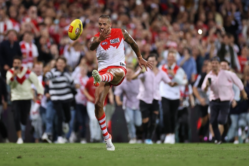 Lance Franklin makes contact with the ball as he kicks for goal