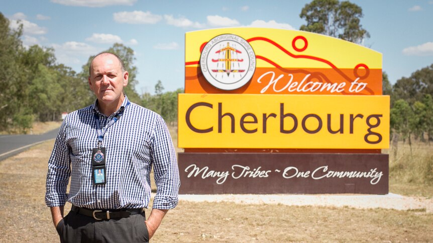 Inspector Scott Stahlhut stands next the 'welcome to Cherbourg' sign.