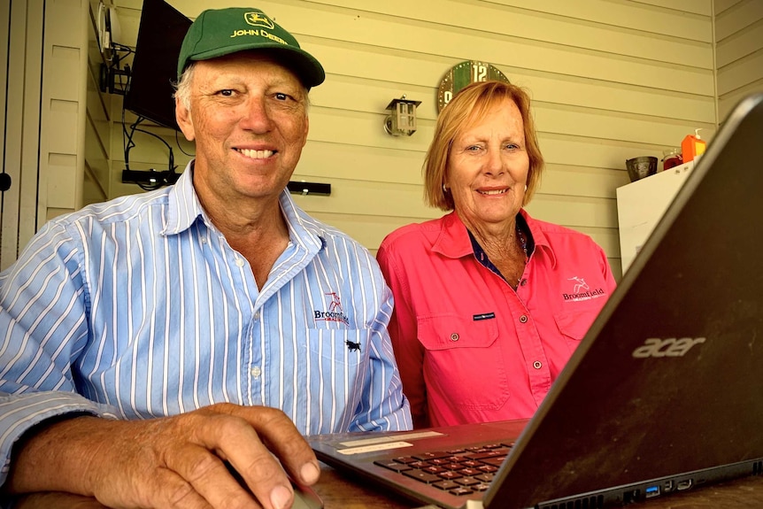 Ian has his hand on the mouse with a laptop in front of him and Sue.