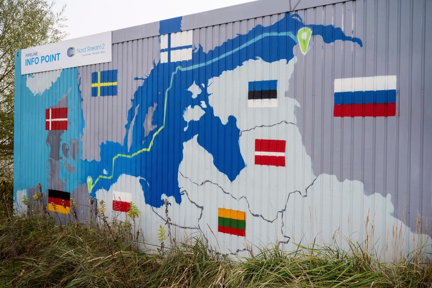 A mural on the side of a building showing the route of the Nord Stream 2 pipeline. 