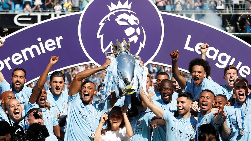Manchester City players hold aloft the 2017-18 Premier League trophy