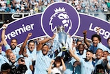 Manchester City players hold aloft the 2017-18 Premier League trophy