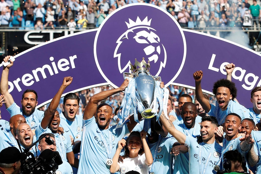 Manchester City players hold aloft the 2017-18 Premier League trophy