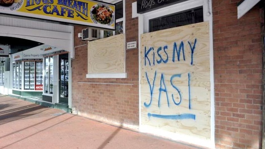 'Kiss my Yasi' message written on a boarded up shopfront in Cairns in Far North Queensland.