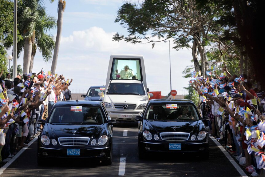 Pope Benedict XVI is driven through Santiago de Cuba.