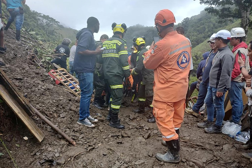 Police help the rescue operations in a landslide.