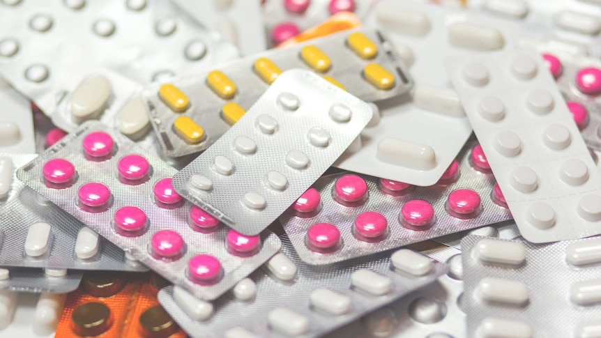 Multiple packets of colourful pharmaceutical medicines.