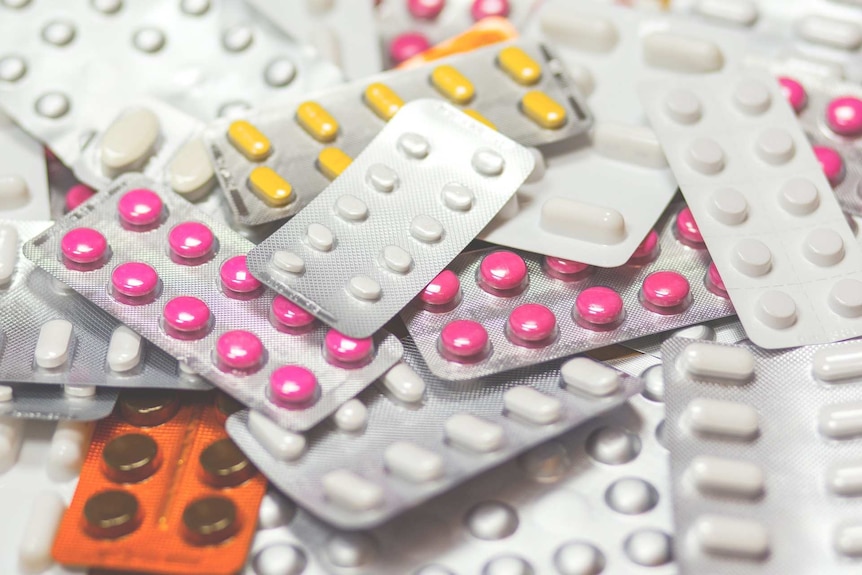 Multiple packets of colourful pharmaceutical medicines.