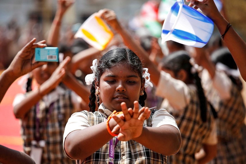 A little girl in India washing her hands