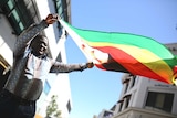 Vusumuzi 'BB' Gumbo lifts the Zimbabwean flag.