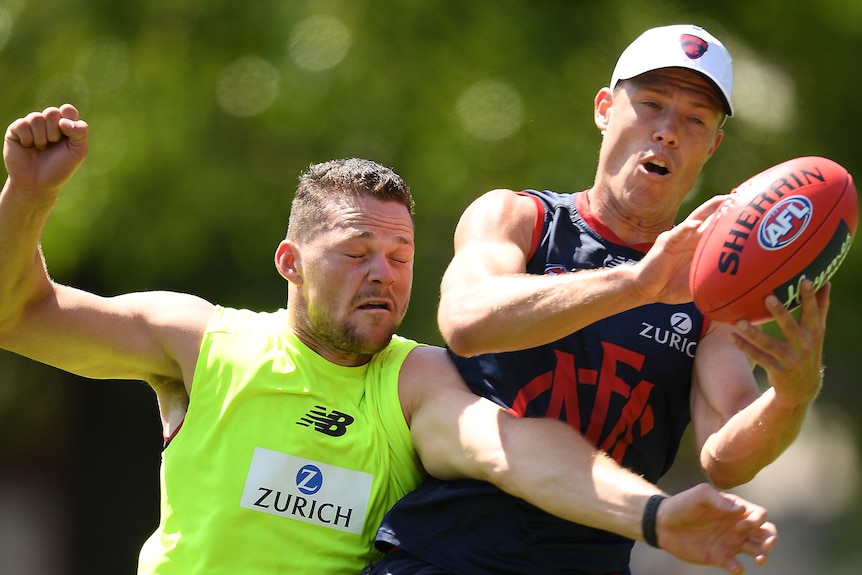 Steven May and Jake Melksham compete for a mark in training kit