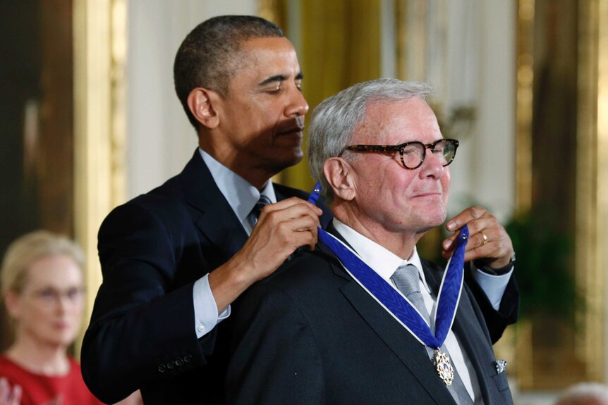 President Barack Obama is seen presenting a medal to Tom Brokaw.