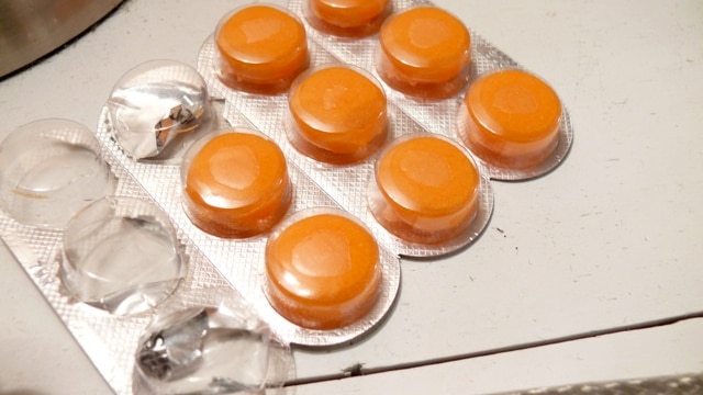 A blister pack of orange throat lozenges