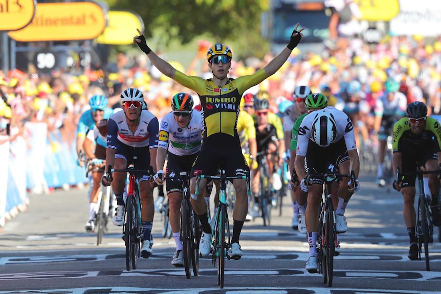 A rider sits up in the saddle as he rolls past the line after winning a stage of the Tour de France.