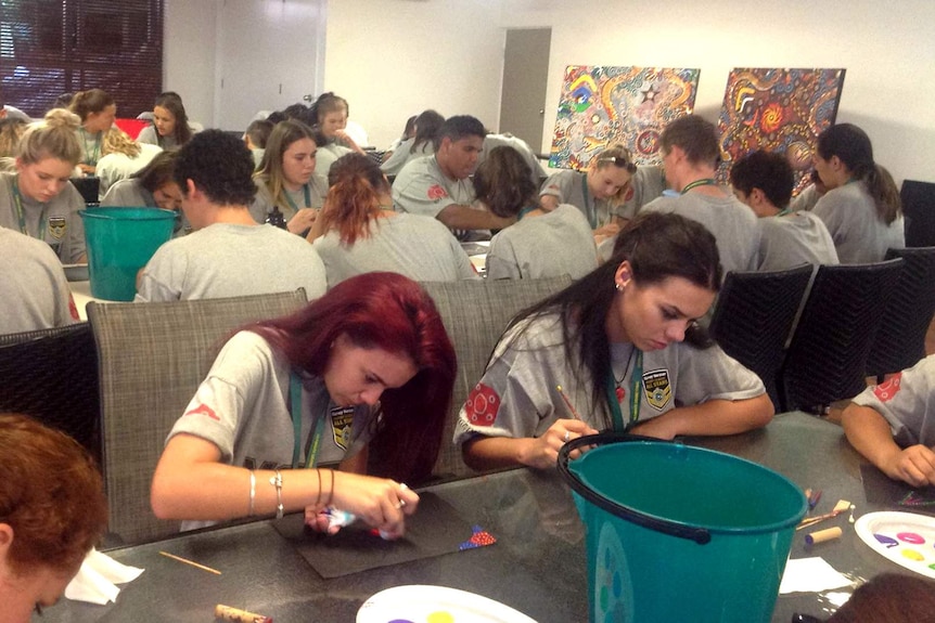 Indigenous students make art in a conference room