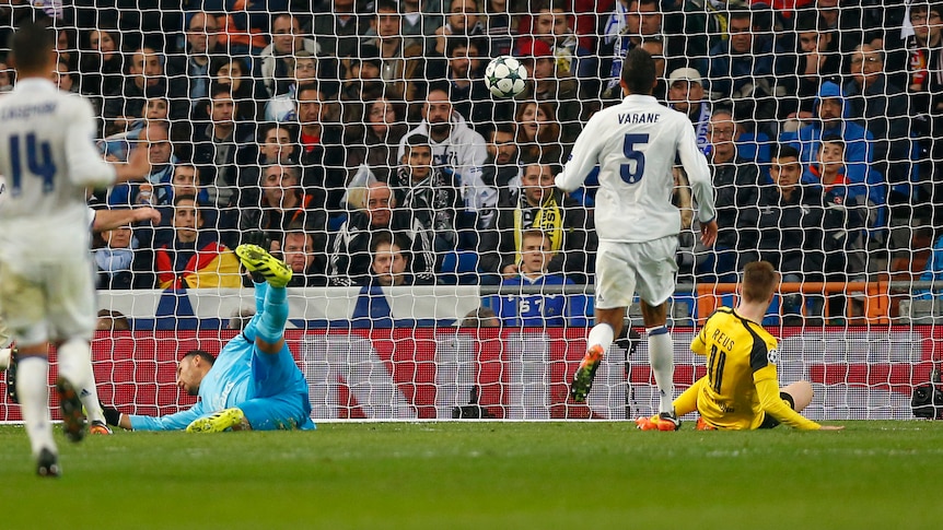 Dortmund's Marco Reus (R) scores against Real Madrid in Champions League on December 7, 2016.