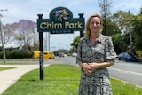 Woman standing in front of a sign saying Chirn Park.